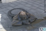 Famous Rubberneck Statue- man sticking out of a hole.
